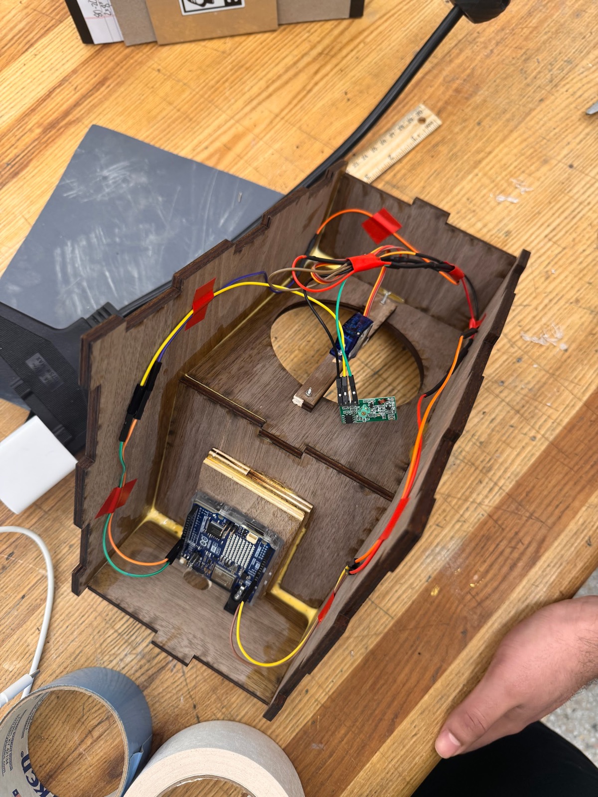 Inside the Bellee chime housing: Arduino, servo, and RF receiver wired into a wooden enclosure