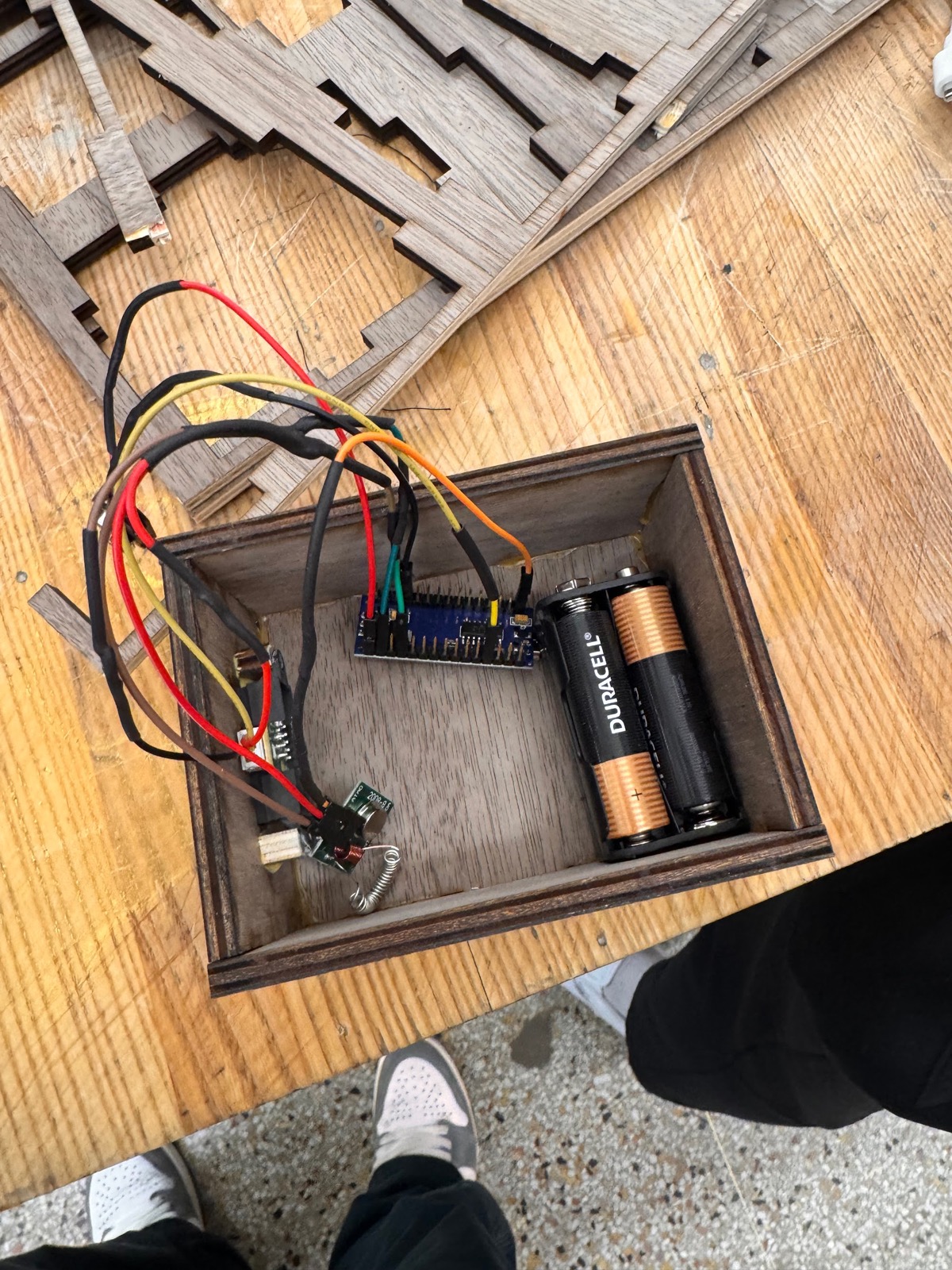 Open wooden sensor box with Arduino Nano, RF module, and AA batteries wired in